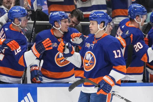 New York Islanders' Matt Martin (17) celebrates with teammates after scoring a goal during the first period of an NHL hockey game against the Washington Capitals, Monday, Jan. 16, 2023, in Elmont, N.Y. (AP Photo/Frank Franklin II)