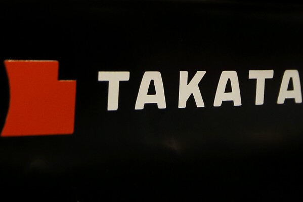 FILE - The logo of Takata Corp. is displayed at an auto supply shop in Tokyo, July 6, 2016. In a document posted Tuesday, Aug. 1, 2023, General Motors announced it is recalling nearly 900 vehicles in the U.S. and Canada with Takata air bag inflators that could explode and hurl shrapnel in a crash. (AP Photo/Shizuo Kambayashi, File)