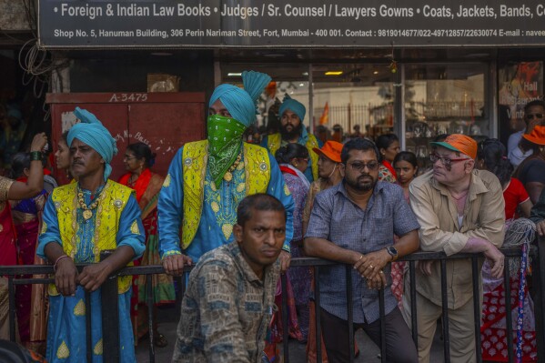 Supporters of National Democratic Alliance watch as their candidates arrive to file nomination papers ahead of national elections in Mumbai, India, Monday, April 29, 2024. (AP Photo/Rafiq Maqbool)
