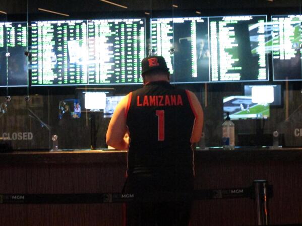 FILE - A man makes a sports bet at the Borgata casino in Atlantic City, N.J., on March 19, 2021, the first full day of the NCAA March Madness basketball tournament. (AP Photo/Wayne Parry, File)