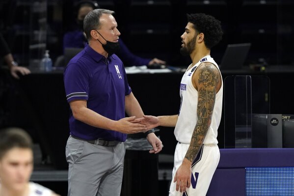 Northwestern head coach Chris Collins, left, celebrates with guard Boo Buie during the second half of an NCAA college basketball game against Michigan State in Evanston, Ill., Sunday, Dec. 20, 2020. Northwestern won 79-65. (AP Photo/Nam Y. Huh)
