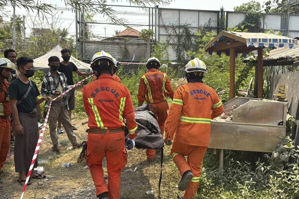 Rescue members carry a dead body from a collapsed building in the aftermath of Friday's earthquake in Mandalay, Myanmar, Thursday, April 3, 2025. (AP Photo)
