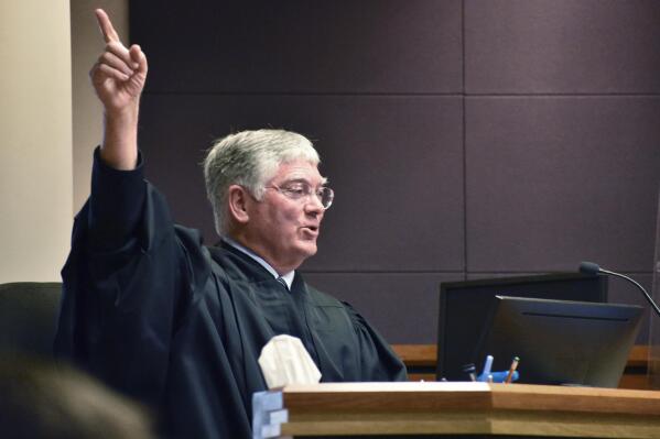 Montana District Judge Michael Moses gestures during a court hearing over a state health department rule that prevents transgender people from changing their birth certificates, Thursday, Sept. 15, 2022, in Billings, Mont. Moses struck down the rule at the conclusion of the hearing. (AP Photos/Matthew Brown)