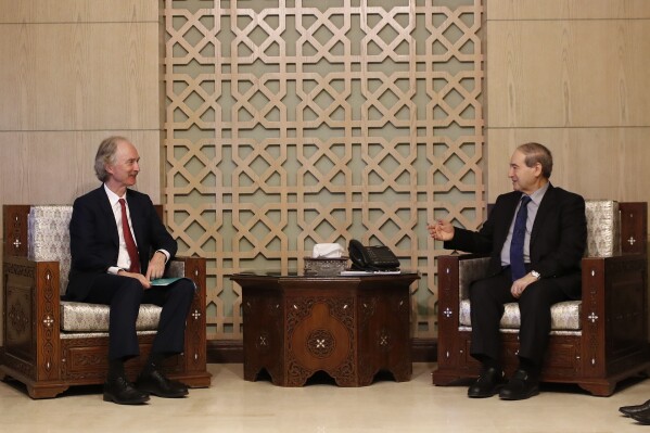 U.N. special envoy for Syria Geir Pedersen, left, meets with Syrian Foreign Minister Faisal Mekdad, in Damascus, Syria Sunday, Sept. 10, 2023. Pedersen said he expects a committee representing the Syrian government and the opposition to resume talks next month over draft constitutional reforms. Pedersen urged donors not to reduce their funding while the war-torn country's economic situation is getting worse. (AP Photo/Omar Sanadiki)