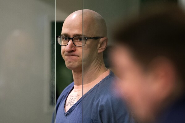 Joseph David Emerson, left, appears in Multnomah County Circuit Court for an indictment hearing in Portland, Ore., on Thursday, Dec. 7, 2023. An Oregon judge says the ex-Alaska Airlines pilot accused of trying to cut the engines of a passenger flight can be released from jail pending trial. Emerson pleaded not guilty to reduced charges of reckless endangerment at his arraignment Thursday. (Dave Killen/The Oregonian via AP, Pool)