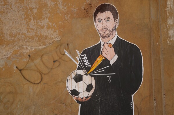 FILE - A mural depicting Juventus president Andrea Agnelli making a hole in a football with a knife, appeared in Rome, Thursday, April 22, 2021 after Juventus was one of the three Italian soccer clubs and founding members of a so-called European Super League. The competition was dealt a fresh blow on Saturday, June 1, 2024, when Italian giant Juventus decided to rejoin the body of clubs opposing the controversial breakaway competition. Madrid and Barcelona are now the only two clubs trying to form a proposed Super League, which has already had one failed launch after angry fan protests in 2021. (AP Photo/Andrew Medichini, file)