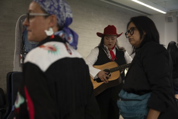 Mexican singer Vivir Quintana waits to perform songs from her new album “Cosas que Sorprenden a la Audiencia” or Things that Surprise the Audience, in Mexico City, Thursday, April 24, 2025. Quintana's first "corridos" album tells the stories of women who were incarcerated for killing their abusers while defending themselves. (AP Photo/Aurea Del Rosario)
