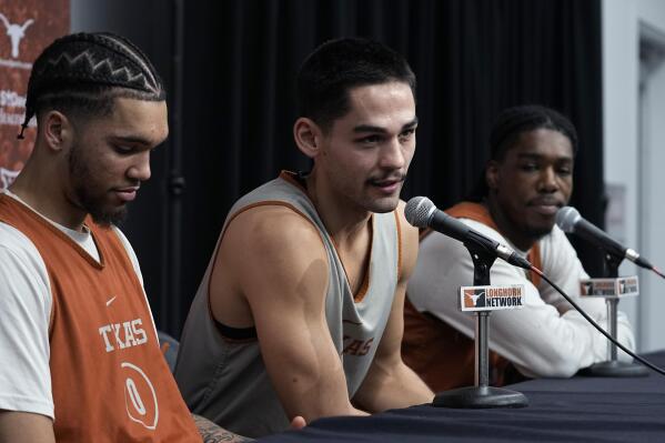Texas Longhorns NCAA college basketball forward Timmy Allen, left, forward Brock Cunningham, center, and guard Marcus Carr, right, take part in a news conference in Austin, Texas, Monday, Jan. 9, 2023. (AP Photo/Eric Gay)