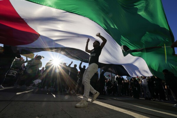 FILE - Demonstrators participate in a solidarity rally for Palestinians, in Milan, Italy on Nov. 11, 2023. (AP Photo/Luca Bruno, File)