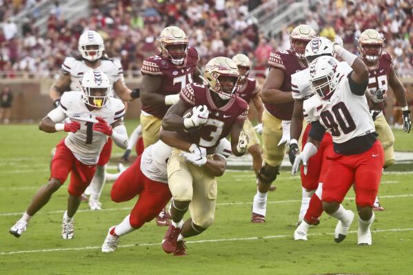 Florida State running back Trey Benson (3) fights for extra yardage as Duquesne defenders pursue in the second quarter of an NCAA college football game Saturday, Aug. 27, 2022, in Tallahassee, Fla. (AP Photo/Phil Sears)
