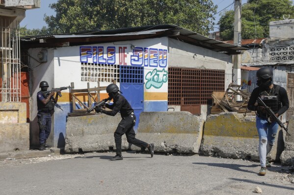 National Police patrol the area near the empty National Penitentiary after a small fire inside the jail in downtown Port-au-Prince, Haiti, Haiti, Thursday, March 14, 2024. This is the same prison that armed gangs stormed late March 2 and hundreds of inmates escaped. (AP Photo/Odelyn Joseph)