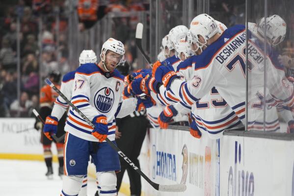 Edmonton Oilers' Connor McDavid (97) is congratulated for his goal during the first period of the team's NHL hockey game against the Anaheim Ducks on Wednesday, Jan. 11, 2023, in Anaheim, Calif. (AP Photo/Jae C. Hong)