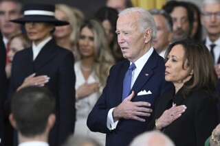 Former President Joe Biden and former Vice President Kamala Harris stand as Christopher Macchio performs "The Star-Spangled Banner" after President Donald Trump was sworn in during the 60th Presidential Inauguration in the Rotunda of the U.S. Capitol in Washington, Monday, Jan. 20, 2025. (Saul Loeb/Pool photo via AP)