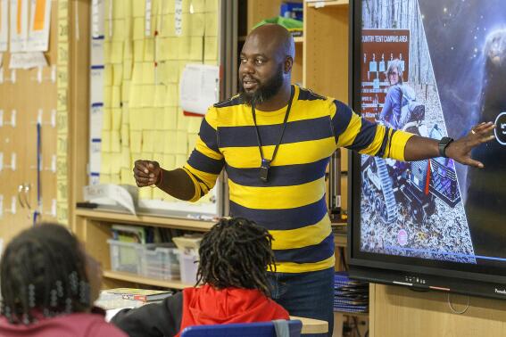 Tyler Wright teaches 4th grade math at Stono Park Elementary School in Charleston, S.C., Friday, Nov. 18, 2022. America's teacher workforce has long been whiter than its student body. In South Carolina, Charleston County aims to increase the number of Black male teachers in the classroom — 60 more in the next three years. While teacher vacancies are affecting all educators, experts say if South Carolina wants its Black students to succeed, it can't afford to lose any more Black men in the classroom. (Grace Beahm Alford/The Post And Courier via AP)