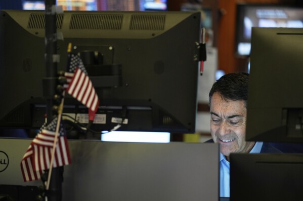 Mark Mueller works on the floor at the New York Stock Exchange in New York, Monday, April 7, 2025. (AP Photo/Seth Wenig)