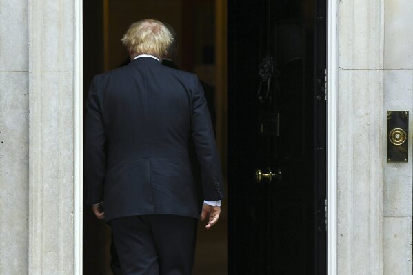 Britain's Prime Minister Boris Johnson walks back into 10 Downing Street after greeting U.S. Vice President Mike Pence in London, Thursday, Sept. 5, 2019. Boxed in by opponents and abandoned politically even by his own brother, Johnson struggled Thursday to keep his Brexit plans on track. (AP Photo/Alberto Pezzali)