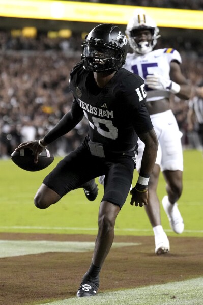 Texas A&M quarterback Marcel Reed (10) scores a touchdown against LSU during the third quarter of an NCAA college football game Saturday, Oct. 26, 2024, in College Station, Texas. (AP Photo/Sam Craft)