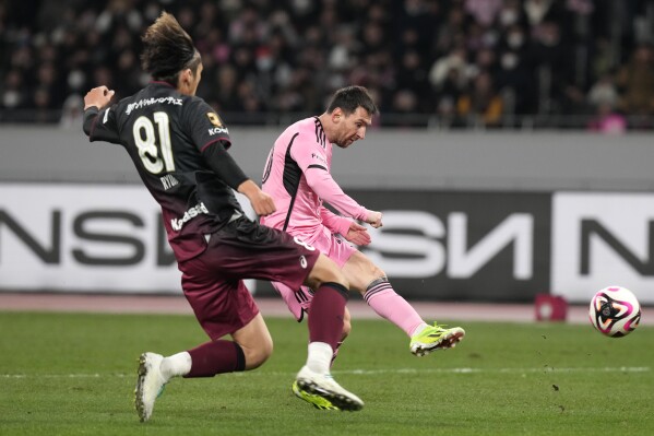 Inter Miami's Lionel Messi, right, battles for the ball against Vissel Kobe's Ryuho Kikuchi during the friendly soccer match between Vissel Kobe and Inter Miami CF at the National Stadium, Wednesday, Feb. 7, 2024, in Tokyo, Japan. (AP Photo/Eugene Hoshiko)