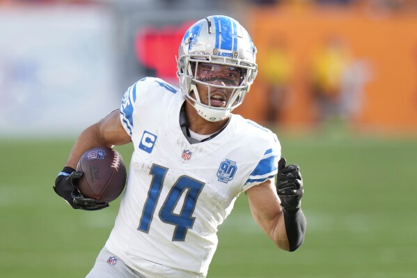 Detroit Lions wide receiver Amon-Ra St. Brown scores on a 27-yard touchdown reception against the Tampa Bay Buccaneers during the first half of an NFL football game Sunday, Oct. 15, 2023, in Tampa, Fla. (AP Photo/Chris O'Meara)