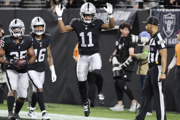 Las Vegas Raiders wide receiver Tre Tucker (11) celebrates after scoring a touchdown against the Los Angeles Chargers during the first half of an NFL football game, Thursday, Dec. 14, 2023, in Las Vegas. (AP Photo/Steve Marcus)