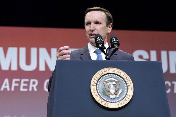 FILE - Sen. Chris Murphy, D-Conn., speaks at the National Safer Communities Summit at the University of Hartford in West Hartford, Conn., Friday, June 16, 2023. Murphy says on Wednesday, Aug. 30, he's reluctantly postponing his annual “Walk Across Connecticut” after testing positive for COVID. The 50-year-old Democrat has been donning his shorts and T-shirt and walking across much of the state since 2016. (AP Photo/Susan Walsh, File)