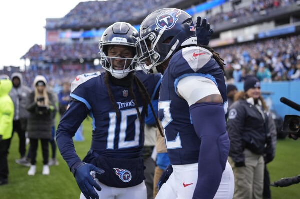 Tennessee Titans running back Derrick Henry, right, celebrates his touchdown run against the Jacksonville Jaguarswith wide receiver DeAndre Hopkins, left, during the first half of an NFL football game Sunday, Jan. 7, 2024, in Nashville, Tenn. (AP Photo/George Walker IV)