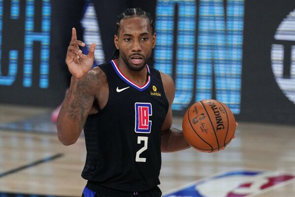 FILE - Los Angeles Clippers' Kawhi Leonard (2) gestures in the second half of an NBA conference semifinal playoff basketball game against the Denver Nuggets in Lake Buena Vista Fla., in this Thursday, Sept 3, 2020, file photo. Kawhi Leonard made a rare late-night television appearance, Wednesday, Dec. 16 with host Jimmy Kimmel kidding the Los Angeles Clippers superstar who avoids attention off the court about being a mysterious man.
“Maybe to the outside world,” Leonard said. “The people around me know who I am.”(AP Photo/Mark J. Terrill, File)