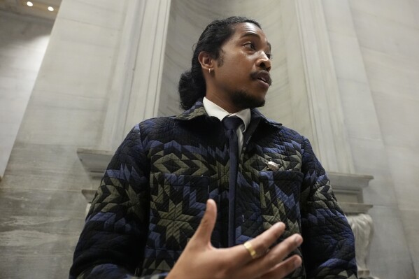 FILE - Rep. Justin Jones, D-Nashville, speaks outside the House chamber after the State of the State address on February 5, 2024 in Nashville, Tennessee.  Disagreements over abortion rights, gun control and the treatment of racial minorities are some of the issues that have led many political leaders to say they cannot take the oath or recite the Pledge of Allegiance.  In Tennessee, Jones declined to lead the pledge during a legislative session earlier this month.  (AP Photo/George Walker IV, File)