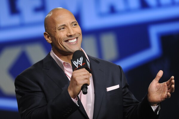 FILE - Actor and former WWE Superstar Dwayne "The rock" Johnson participates in a Wrestlemania XXVII press conference at the Hard Rock Café in Times Square on Wednesday, March 30, 2011 in New York.  It's a name that has become almost synonymous with professional wrestling, but the bearer of it, Dwayne Johnson, has never legally owned it. 