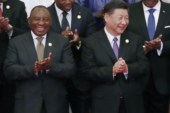 FILE - Chinese President Xi Jinping, right, with South African President Cyril Ramaphosa, left, at the Forum on China-Africa Cooperation in Beijing. China Sept. 3, 2018. Russia and China will look to gain more political and economic ground in the developing world at a summit of the BRICS bloc in South Africa this week. (How Hwee Young/Pool Photo via AP, File)