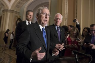 Senate Majority Leader Mitch McConnell, R-Ky., flanked by Sen. John Thune, R-S.D., left, and Senate Majority Whip John Cornyn, R-Texas, speaks with reporters following weekly policy luncheons where they discussed school safety measures in response to the Parkland, Fla., assault that left 17 dead, at the Capitol in Washington, Tuesday, Feb. 27, 2018. (AP Photo/J. Scott Applewhite)