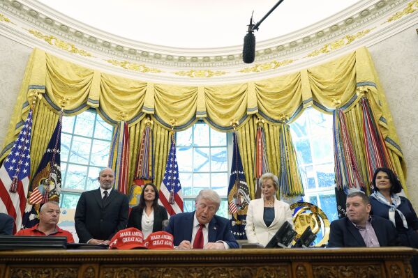 President Donald Trump signs an executive order regarding education in the Oval Office of the White House, Wednesday, April 23, 2025, in Washington, as Commerce Secretary Howard Lutnick, Labor Secretary Lori Chavez-DeRemer and Education Secretary Linda McMahon watch. (AP Photo/Alex Brandon)
