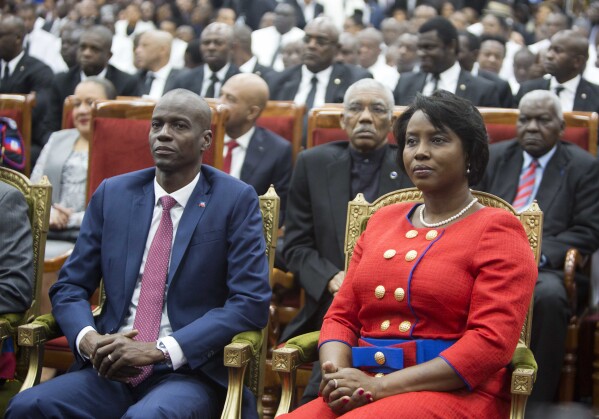 FILE Haiti's President Jovenel Moise sits with his wife Martine during his swearing-in ceremony at Parliament in Port-au-Prince, Haiti, Tuesday Feb. 7, 2017. A judge investigating the July 2021 assassination of President Moïse issued a final report on Monday, Feb. 19, 2024, that indicts his widow, Martine Moïse, ex-prime minister Claude Joseph and the former chief of Haiti’s National Police, Léon Charles, among others. (AP Photo/Dieu Nalio Chery, File)