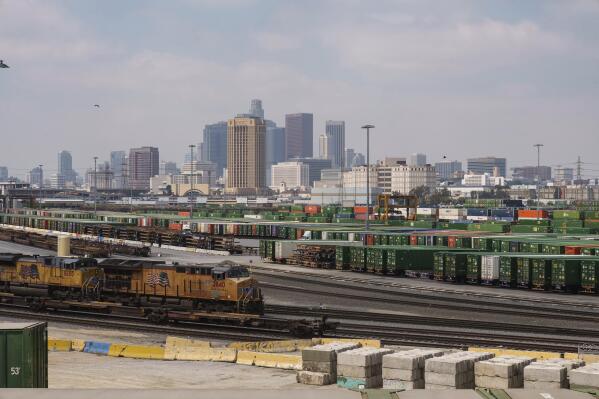Los Angeles skyline is seen above the Union Pacific LATC Intermodal Terminal is seen on Tuesday, April 25, 2023 in Los Angeles. California's Air Resources Board is set to vote on a rule to cut greenhouse gas and smog-forming emissions from diesel-powered locomotives used to pull rail cars through ports and railyards. (AP Photo/Damian Dovarganes)