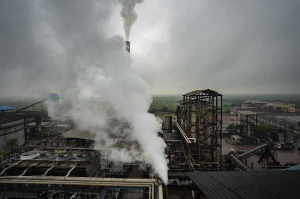 Smoke and steam rise from distillery at Bajaj Hindustan Sugar factory, one of Asia's largest ethanol (biofuel) manufacturers in Meerut, India, Wednesday, Aug. 23, 2023. India, the current president of the Group of 20 industrialized and developing nations, has proposed a global biofuel alliance that seeks to accelerate sustainable biofuels deployment to support the global energy transition. (AP Photo/Altaf Qadri)