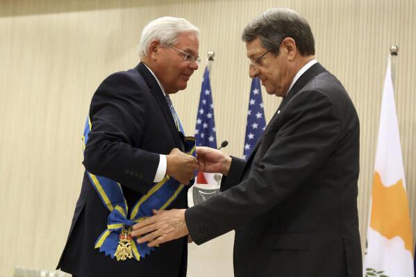 U.S. Senate Foreign Relations Committee Chairman Robert Menendez, left, receives Cyprus' highest honor - the Grand Collar of the Order of Makarios III - from President Nicos Anastasiades during a ceremony at the Presidential Palace in the capital Nicosia, Monday, Aug. 30, 2021. Menendez, the Democratic senator from New Jersey said that the "retrograde vision" of Turkey's president to cement Cyprus' ethnic divide by striving for a two-state deal "is wrong" for all Cypriots. (AP Photo/Philippos Christou)