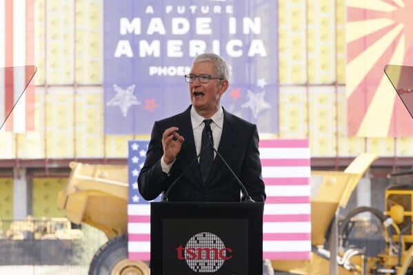 File - Apple CEO Tim Cook speaks at the Taiwan Semiconductor Manufacturing Company facility under construction in Phoenix, on Dec. 6, 2022. Multinational corporations are seeking to produce more items - especially semiconductors - in the United States. Apple will use chips made at the facility. (AP Photo/Ross D. Franklin, File)