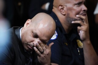 FILE - U.S. Capitol Police Sgt. Aquilino Gonell, left, and U.S. Capitol Police Sgt. Harry Dunn react as they watch a video as the House select committee investigating the Jan. 6, 2021, attack on the U.S. Capitol holds a hearing on Capitol Hill in Washington, Oct. 13, 2022. A visit to the Pennsylvania House floor by the two former police officers who helped protect the U.S. Capitol during the Jan. 6 riot drew boos and walkouts by some Republican members on Wednesday, June 5, 2024, as the chamber was wrapping up business for the week. (AP Photo/Jacquelyn Martin, File)