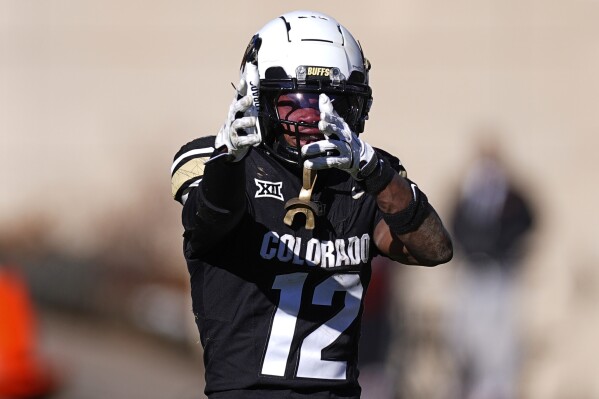 Colorado wide receiver Travis Hunter (12) reacts in the second half of an NCAA college football game Friday, Nov. 29, 2024, in Boulder, Colo. (AP Photo/David Zalubowski, File)
