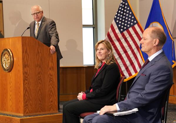 Minnesota Gov. Tim Walz speaks at a podium as Senate Majority Leader Paul Gazelka, R-East Gull Lake, right to left, and House Speaker Melissa Hortman, DFL-Brooklyn Park, listened in during a press conference Monday, May 17, 2021, in St. Paul, Minn., announcing the Legislature and Walz agreed to spend $52 billion on the next two-year budget. (David Joles/Star Tribune via AP)