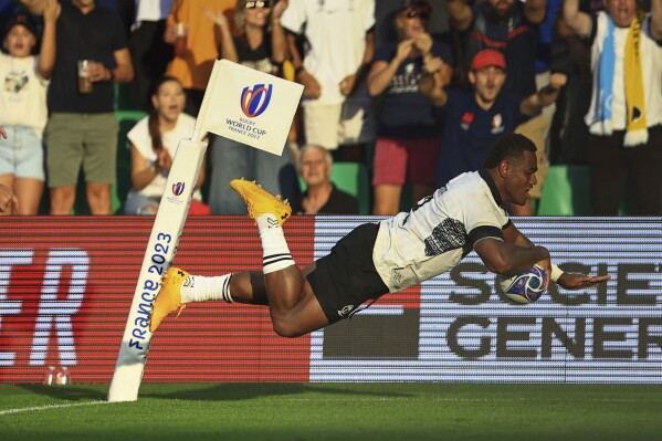 Fiji's Josua Tuisova scores a try during the Rugby World Cup Pool C match between Australia and Fiji at the Stade Geoffroy Guichard in Saint-Etienne, France, Sunday, Sept. 17, 2023. (AP Photo/Aurelien Morissard)