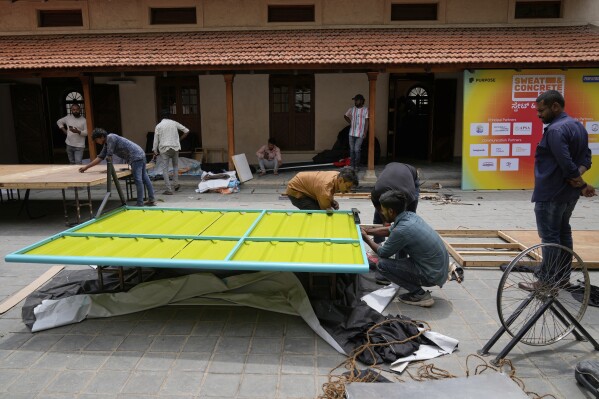 Workers assemble Neralu, an innovative portable heat shelter, before installing it at the Sweat and Concrete 2025 event in Bengaluru, India, Wednesday, May 28, 2025. (AP Photo/Aijaz Rahi)