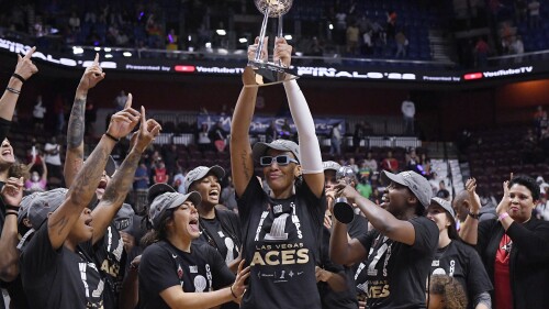 FILE - Las Vegas Aces' A'ja Wilson holds up the championship trophy as she celebrates with teammates after their win in the WNBA basketball finals against the Connecticut Sun, Sept. 18, 2022, in Uncasville, Conn. The Las Vegas Aces are having a historic season so far, but anything short of repeating as WNBA champions would be seen as a failure. (AP Photo/Jessica Hill, File)