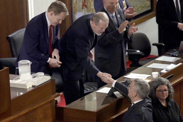 Speaker of the House Destin Hall, R-Caldwell, top left, and Senate leader Phil Berger, R-Rockingham, top center, greet North Carolina Gov. Josh Stein, bottom right, as he arrives to deliver the State of the State address at the Legislative Building, March 12, 2025, in Raleigh N.C. (AP Photo/Chris Seward, file)
