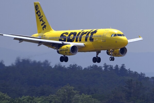 FILE - A Spirit Airlines 319 Airbus approaches Manchester Boston Regional Airport for a landing, Friday, June 2, 2023, in Manchester, N.H. Shares of Spirit Airlines jumped in morning trading Friday, Jan. 19, 2024, after the struggling discount carrier boosted its fourth-quarter guidance after a strong holiday travel season. Spirit said it expects to post revenue of $1.3 billion when it releases its results for the final quarter of 2023 early next month. (AP Photo/Charles Krupa)