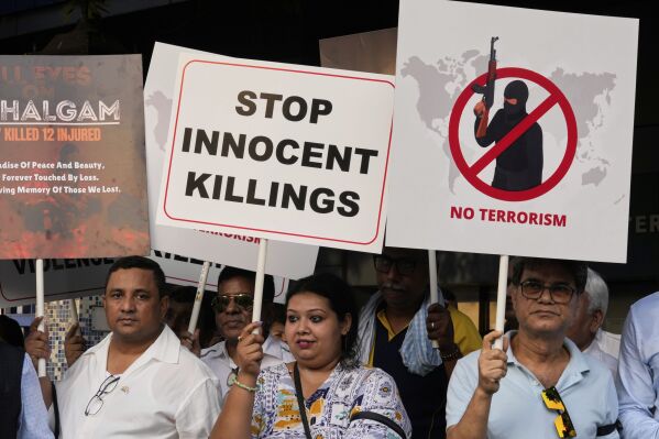Members of airlines and tourism facility providers walk with posters during a protest against the killing of tourists by militants near Pahalgam in Indian controlled Kashmir, in Kolkata, India, Thursday, April 24, 2025. (AP Photo/Bikas Das)