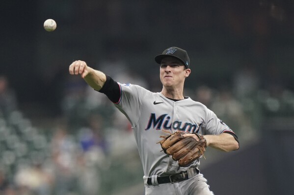 FILE - Miami Marlins' Joey Wendle throws to first during the team's baseball game against the Milwaukee Brewers on Sept. 11, 2023, in Milwaukee. The New York Mets filled two more holes Thursday, Nov. 30, signing utility infielder Wendle and reliever Austin Adams to one-year contracts. (AP Photo/Aaron Gash, File)