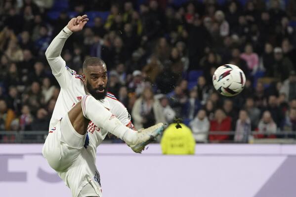 FILE - Lyon's Alexandre Lacazette controls the ball during the French League One soccer match between Lyon and Nantes at the Groupama stadium, in Decines, near Lyon, France, Friday, March 17, 2023. Alexandre Lacazette's goals have papered over Lyon's defensive frailties and are now helping the club's late push for a European place next season. That was glaringly evident last Sunday, May 7, 2023, when the striker's remarkable four-goal performance helped Lyon beat Montpellier 5-4 after trailing 4-1. (AP Photo/Laurent Cipriani, File)