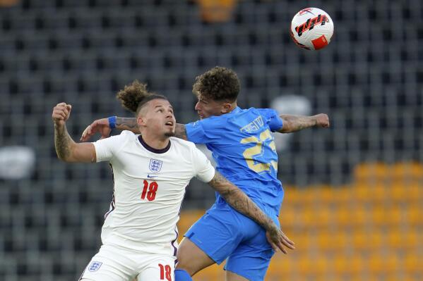 Kalvin Philips of England, left, and Salvatore Esposito of Italy battle for the ball during the Nations League soccer match between England and Italy at Molineux Stadium in Wolverhampton, England, Saturday, June 11, 2022. (AP Photo/Jon Super)