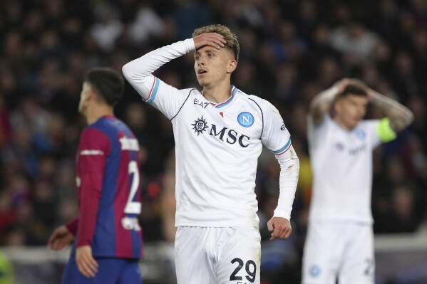 Napoli's Jesper Lindstrom reacts after a missed scoring opportunity during the Champions League, round of 16, second leg soccer match between Barcelona and SSC Napoli at the Olympic Lluis Companys stadium in Barcelona, Spain, Tuesday, March 12, 2024. (AP Photo/Emilio Morenatti)
